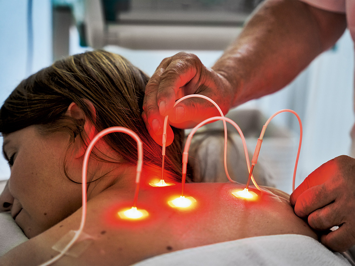Non-invasive laser therapy applied to a woman's back