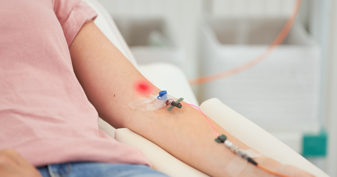 Photo of intravenous laser therapy, woman with a cannula in the crook of her elbow